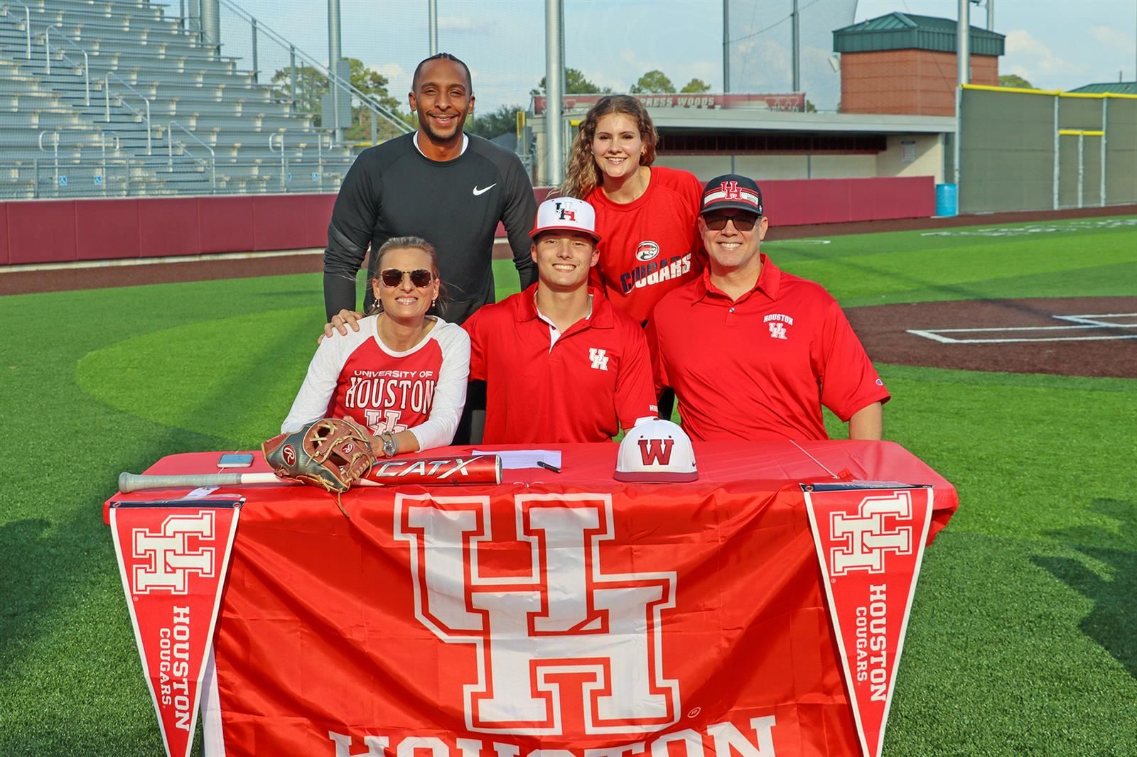 Cypress Woods senior Tristin Russell, seated center, signed a letter of intent to play baseball at the University of Houston.